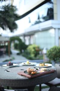 a table with two plates of food on it at Adden Palace Hotel & Conference Centre in Mwanza