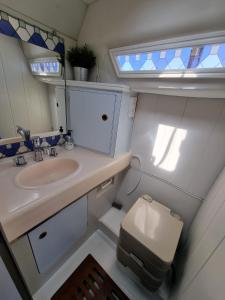 a small bathroom with a sink and a toilet at Experiencia en el mar Gijon M in Gijón