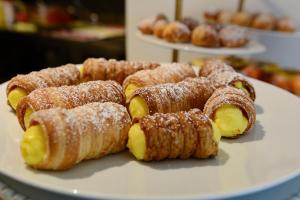 a white plate of pastries on a table at Resort Miramonti in Forte dei Marmi