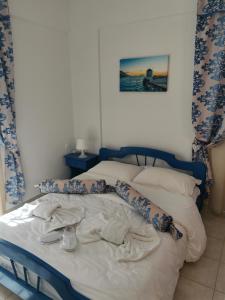 a bedroom with a bed with pillows on it at Aiantas in Ermoupoli