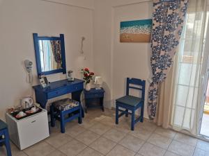 a room with blue chairs and a blue vanity and mirror at Aiantas in Ermoupoli