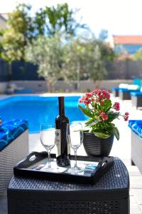 a tray with a bottle of wine and two glasses at Endless Summer House Barbara Zadar in Zadar