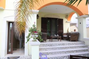 a house with a staircase leading to the front door at LA TAVERNETTA degli ARTISTI in Monteroni di Lecce