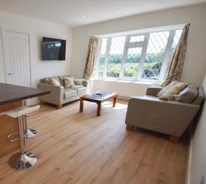 a living room with a couch and a table at Vale View Scalford in Scalford