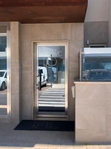 a door to a building with a car in it at Casa Giorgia Monopoli in Monopoli