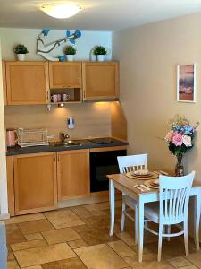 a kitchen with a table and chairs and a sink at Happy Studio Sea View in Topola