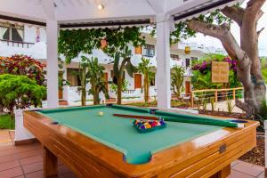 a pool table sitting on top of a patio at Hotel Fiesta in Puerto Ayora