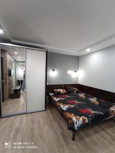 a bedroom with two beds and a large mirror at lark apartment in Dnipro