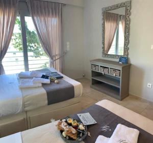 a hotel room with two beds and a mirror at Villa theosis in Nikiana