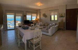 a living room with a table and a couch at Villa theosis in Nikiana