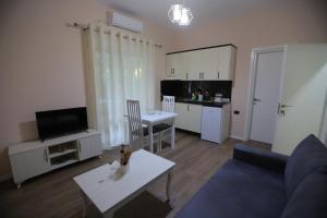 a living room filled with furniture and a tv at D1 Hostel in Tirana
