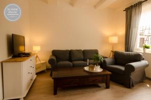 a living room with a couch and a coffee table at Ferienwohnung Scandic Hygge Bevern im Weserbergland in Bevern