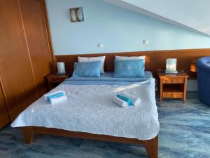 a bedroom with a bed with two containers on it at Tazex Apartments in Herceg-Novi