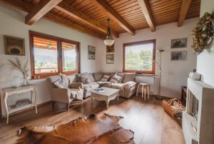 a living room with a couch and a table at Dom pod Wiankami in Korczyna