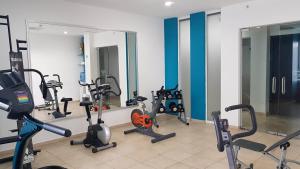 a gym with a bunch of exercise bikes and mirrors at HOTEL OLIBA Boca del Rio in Boca del Río