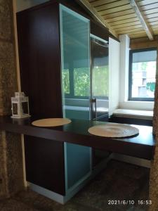 a bathroom with two sinks and a glass wall at Casa das Andorinhas in Póvoa de Lanhoso