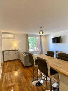 a living room with a table and chairs and a couch at Maison de la Marine in Cagnes-sur-Mer