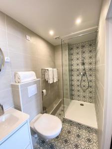 a bathroom with a shower and a toilet and a sink at Maison de la Marine in Cagnes-sur-Mer