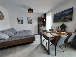 Sala de estar con cama y mesa de comedor en Apartmán Rezidence Javor Železná Ruda, en Železná Ruda