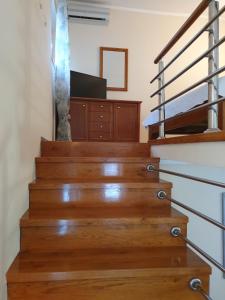 a stairway with wooden stairs with a television on it at Tazex Apartments in Herceg-Novi