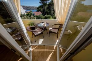 a balcony with a table and chairs and a view at Apartments Sole in Rab