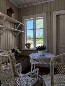 a porch with a table and chairs and a window at Willa Viktor in Kristinestad