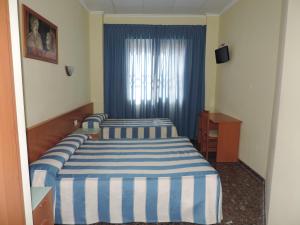 Cama ou camas em um quarto em Hotel Costa San Antonio