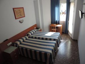 Cama ou camas em um quarto em Hotel Costa San Antonio
