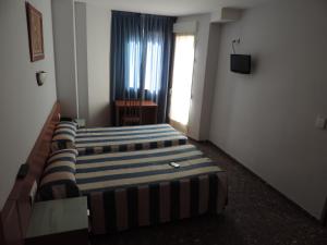 Cama ou camas em um quarto em Hotel Costa San Antonio