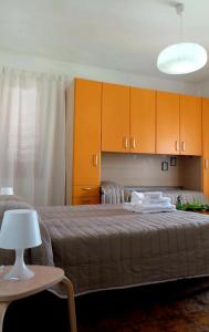 a bedroom with two beds and a table with a lamp at A Casa Di Nonna B&B in Tortoreto Lido