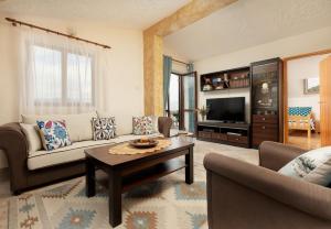 a living room with a couch and a coffee table at Apartment Sea Breeze in Luštica