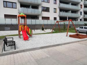 a playground in front of a apartment building at Noce w Jelonce - Nowoczesny Apartament typu Studio w Centrum Jeleniej G - z garażem dla 1-4 osób in Jelenia Góra
