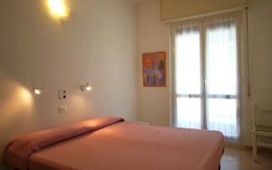 a bedroom with a bed and a window at Appartamenti family & MTB in Finale Ligure