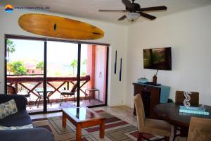 una sala de estar con una tabla de surf colgada en la pared en Marina Pinacate A-316 en Puerto Peñasco