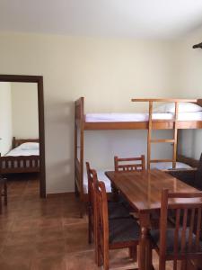 a dining room with a table and two bunk beds at Shyqi Apartments in Velipojë