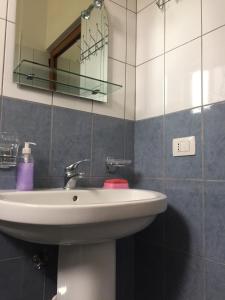 a bathroom with a sink and a mirror at Shyqi Apartments in Velipojë +16 photos