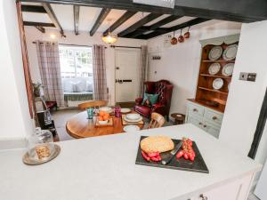 a kitchen with a table with a sandwich on a counter at Crooked Cottage in Kirkbymoorside