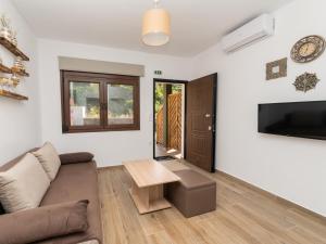 a living room with a couch and a table at MAD'S Villas in Nea Peramos
