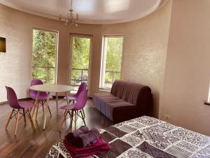 a bedroom with a bed and a table and chairs at дача in Odesa