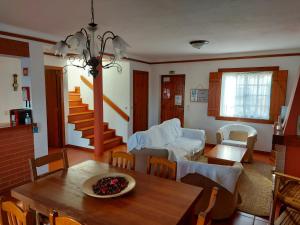 a living room with a table and a dining room at Space Monte da Rosa in Vila Nova de Milfontes