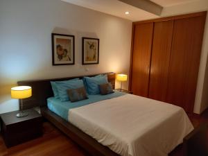 a bedroom with a large bed with two lamps at La Suite Calypso in Luz +72 photos