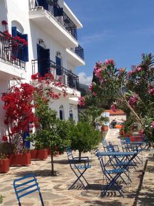 a group of blue chairs in front of a building at Hotel Maria-Elena in Agios Kirykos