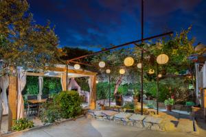 a restaurant with a lit up patio at night at Apartments Mario in Pula