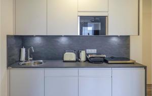 a kitchen with a sink and a counter top at Amazing Apartment In Kappeln With House Sea View in Kappeln