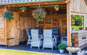 a patio with blue chairs and a house at 1 Bedroom Cozy Apartment In Kappeln in Kappeln