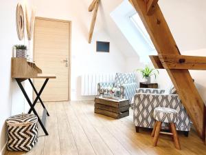 a room with two chairs and a table in a attic at Aux 2 girouettes in Merville