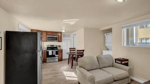 a living room with a chair and a kitchen at Your Nest Away from Home in Colorado Springs