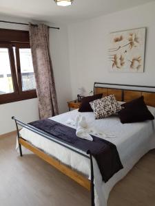 a bedroom with a bed in a room with a window at El Rincón de Cambados in Cambados