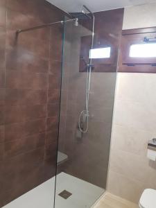 a bathroom with a shower with a glass door at El Rincón de Cambados in Cambados +13 photos