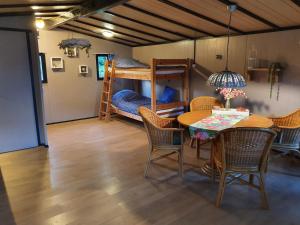 a room with a table and chairs and a bunk bed at Westerslag in Lathen